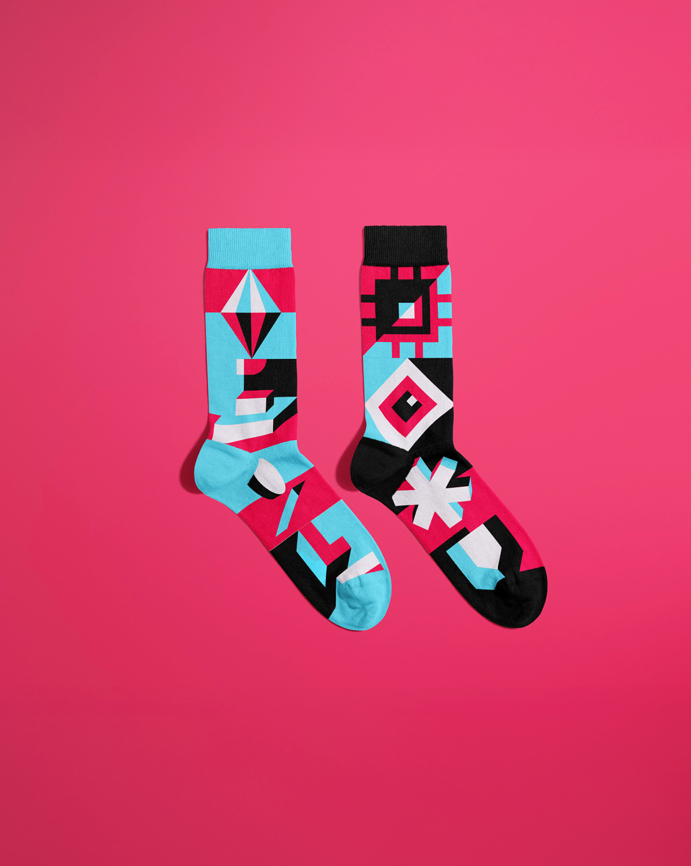 Linen brand visual — geometric patterned socks on pink backdrop