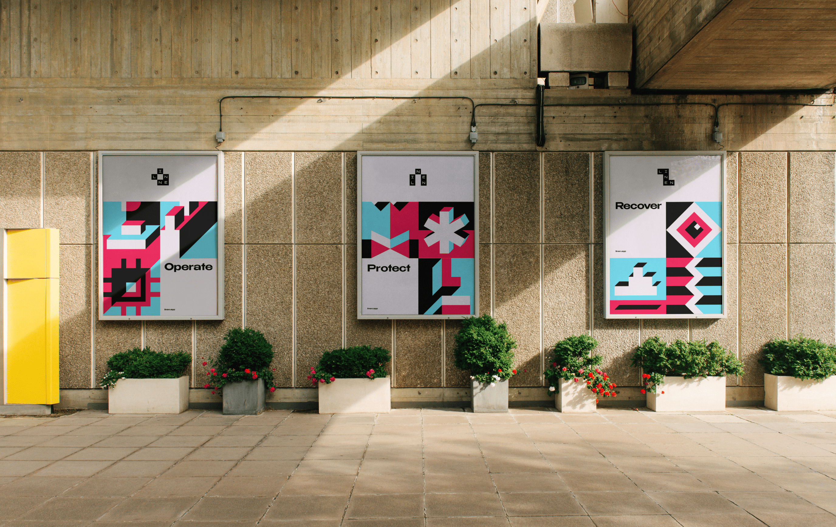 Linen brand visual — Operate Protect Recover posters on concrete wall