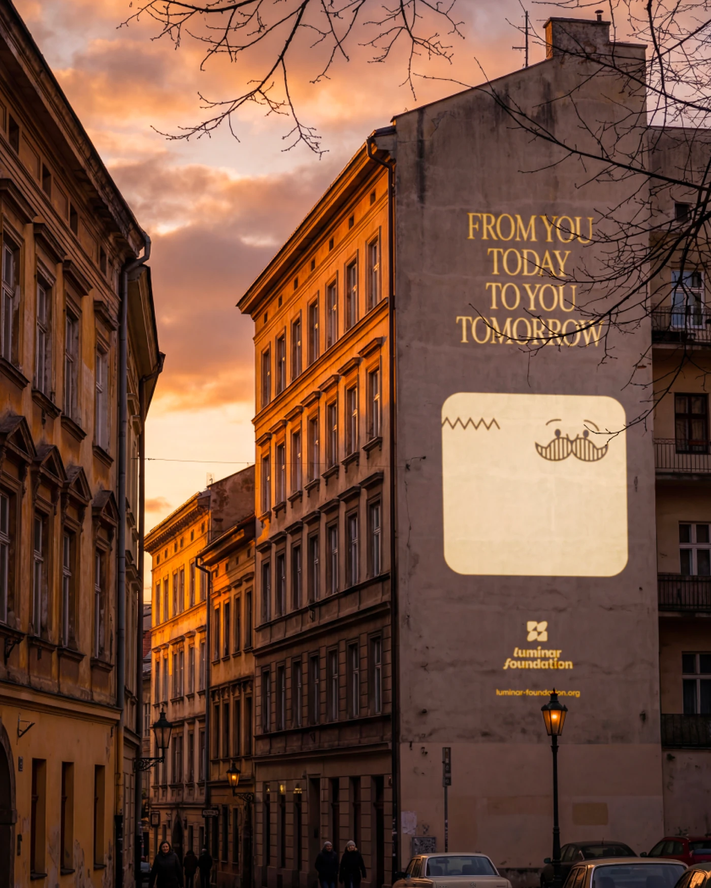 Luminar outdoor brand visual — projected mural on building at sunset
